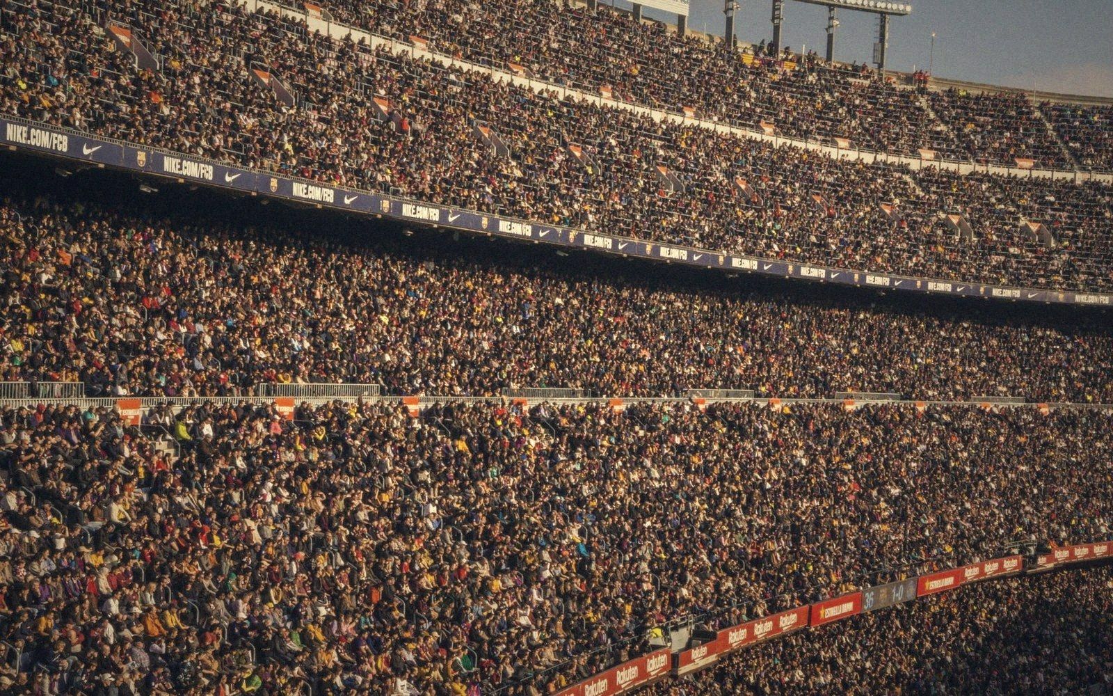 A packed stadium stand seen from high up and far away